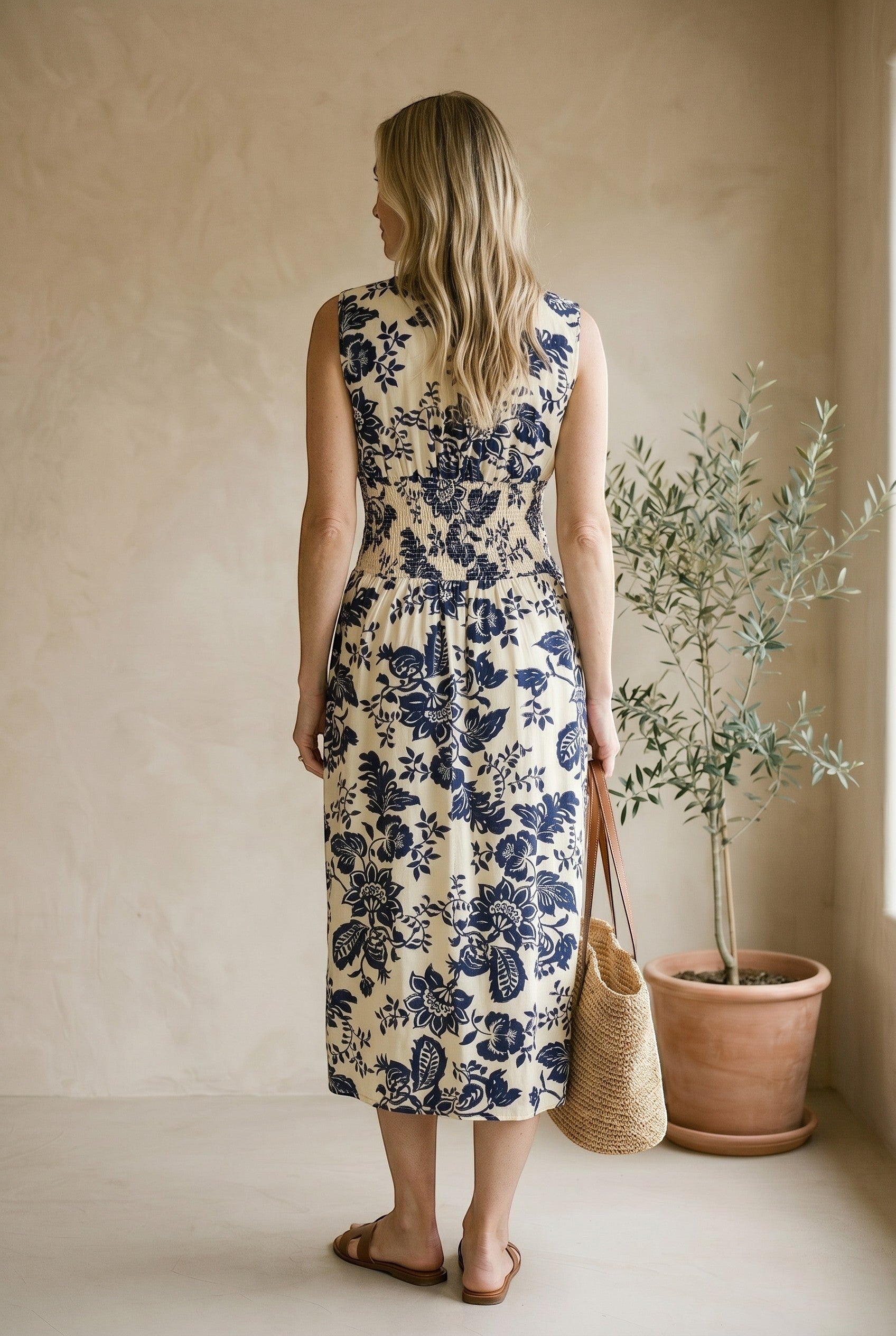 Navy and ivory V-neck smocked waist midi dress by Doe and Rae, featuring a flowy silhouette and elegant design.