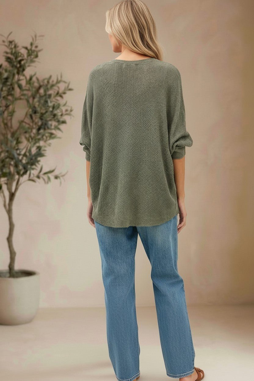 graced forest green dolman long sleeve knit sweater with a relaxed fit worn with blue jeans