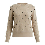 graced beige crewneck sweater featuring a black polka dot knit pattern and ribbed cuffs in a classic fit.