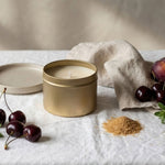 Gold tin candle by graced featuring a sleek label, designed for home fragrance with natural soy wax for a warm, inviting ambiance.