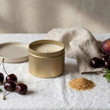 Gold tin candle by graced featuring a sleek label, designed for home fragrance with natural soy wax for a warm, inviting ambiance.