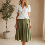 Camellia embroidered peplum blouse with pleated details, featuring intricate embroidery and a stylish, feminine fit.
