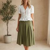 Camellia embroidered peplum blouse with pleated details, featuring intricate embroidery and a stylish, feminine fit.