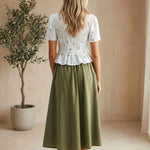 Embroidered peplum blouse by Camellia featuring pleated design, intricate embroidery, and elegant long sleeves.