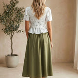 Embroidered peplum blouse by Camellia featuring pleated design, intricate embroidery, and elegant long sleeves.