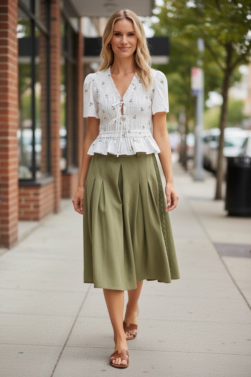 Camellia embroidered peplum blouse featuring pleated design and intricate embroidery, stylish top for casual or dressy occasions.