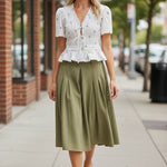 Camellia embroidered peplum blouse featuring pleated design and intricate embroidery, stylish top for casual or dressy occasions.