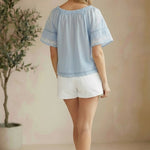 Blue embroidered raglan short sleeve top by Lovestitch, showcasing floral embroidery and casual blouse style.