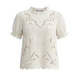 Off-white embroidered short sleeve blouse by Camellia featuring delicate floral embroidery and a relaxed fit.