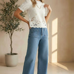 Off-white embroidered short sleeve blouse by Camellia, featuring delicate floral embroidery and lightweight fabric.