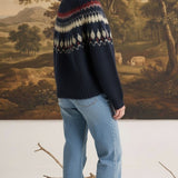 graced Fair Isle crew neck sweater in navy with geometric pattern worn by a woman with light blue jeans
