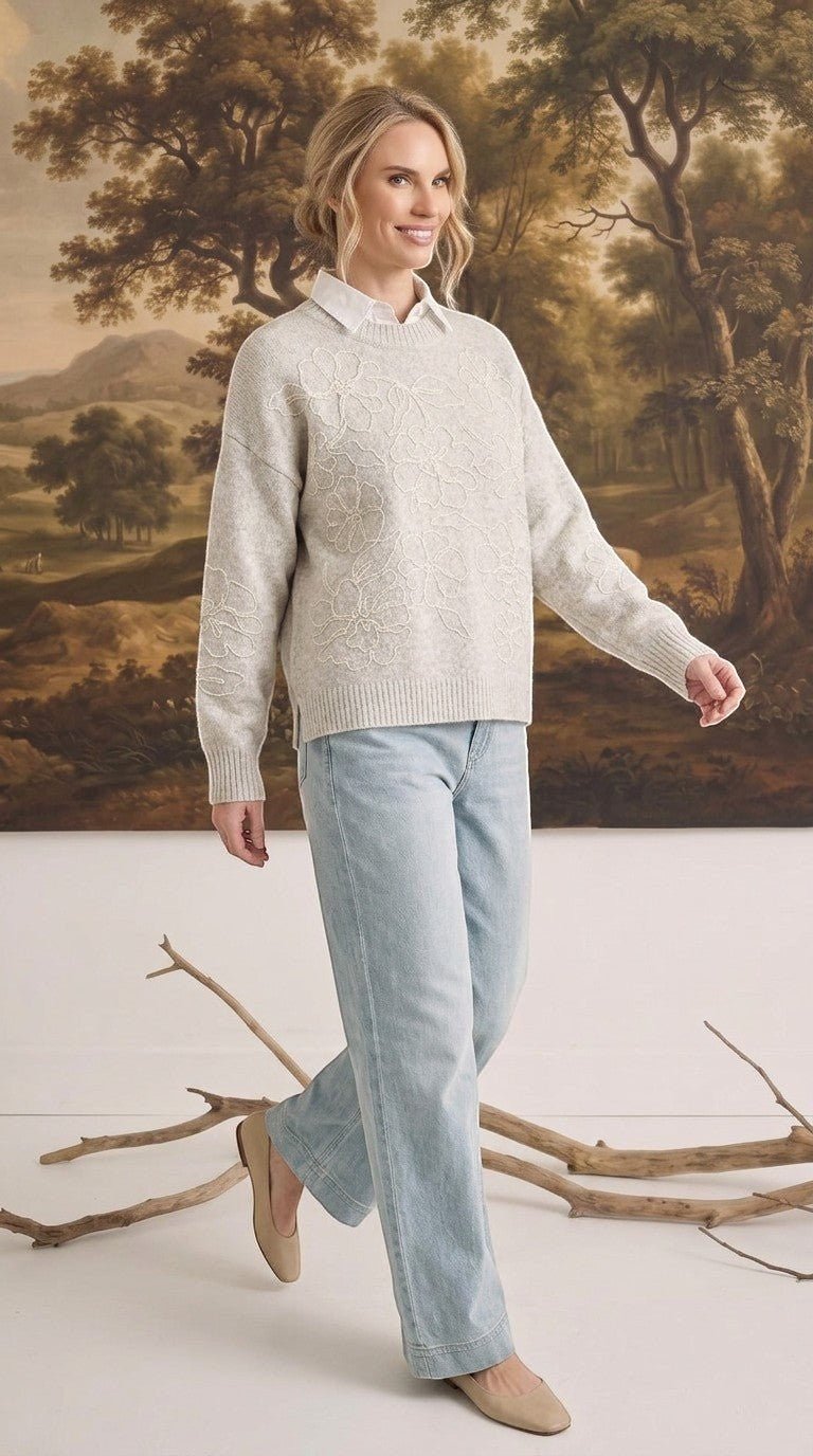 graced floral embroidered pullover sweater in beige worn over a white collared shirt with light wash jeans