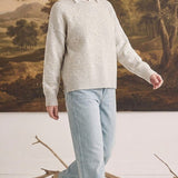 graced floral embroidered pullover sweater in beige worn over a white collared shirt with light wash jeans