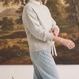 graced floral embroidered light grey pullover sweater worn by a woman with light blue jeans