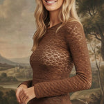 graced mocha floral lace knit top with long sleeves worn by a smiling blonde model against a painted landscape backdrop