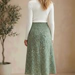 graced floral print midi skirt in green polyester with a flowing silhouette worn by a model from behind