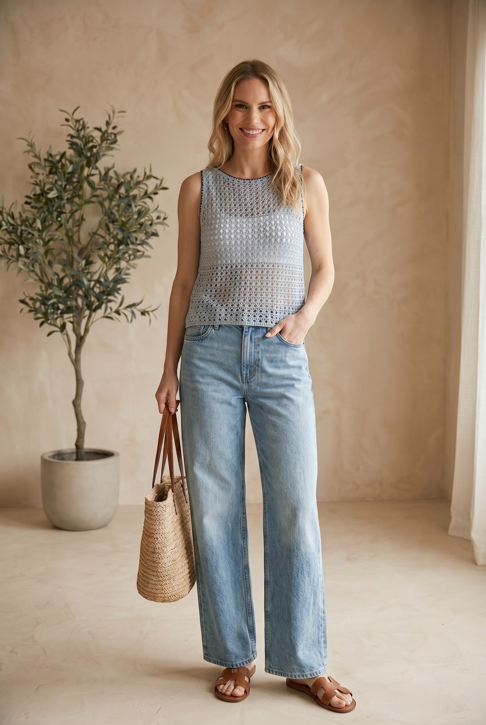 Blue Forte sleeveless crochet knit tank top made of cotton, featuring intricate crochet patterns and a sleeveless design.