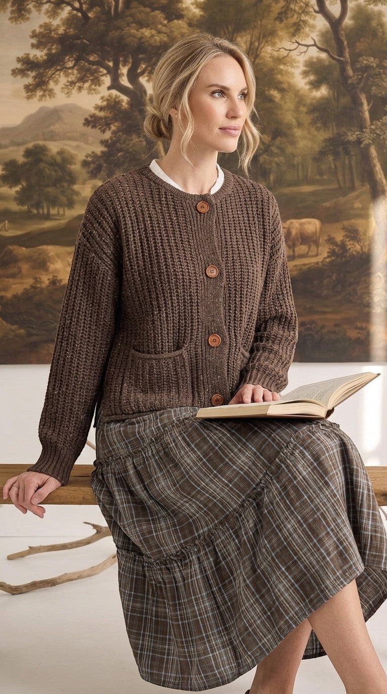 graced Amanda brown ribbed knit cardigan with raw edges and button front worn by a woman reading a book