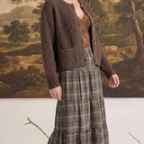 graced Amanda raw edge knit cardigan in dark brown worn by a woman with a plaid tiered skirt and lace camisole