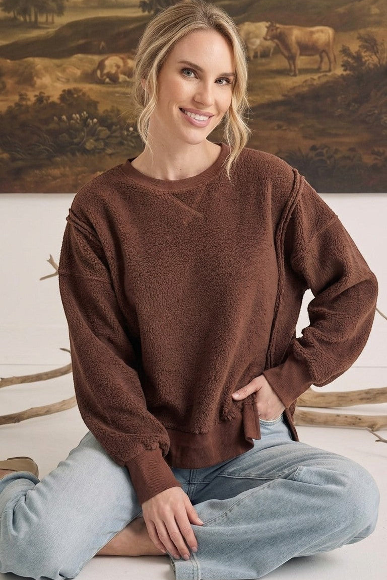 graced The Ashley oversized chocolate brown brushed fleece top with long sleeves worn by a smiling model