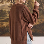 graced The Ashley oversized chocolate brown fleece top with side slits worn by a woman against a landscape backdrop