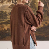 graced The Ashley oversized chocolate brown fleece top with side slits worn by a woman against a landscape backdrop