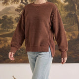 graced The Ashley oversized chocolate brown brushed fleece top with side slits worn by a blonde model with jeans