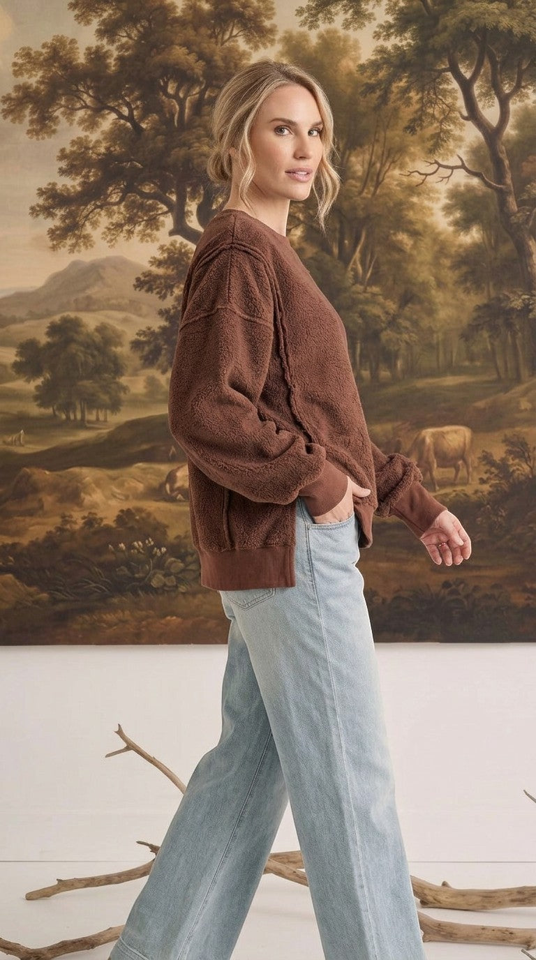 graced The Ashley oversized chocolate brown fleece top with long sleeves and ribbed cuffs worn by a blonde model