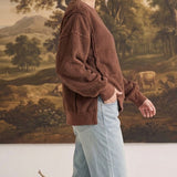 graced The Ashley oversized chocolate brown fleece top with long sleeves and ribbed cuffs worn by a blonde model