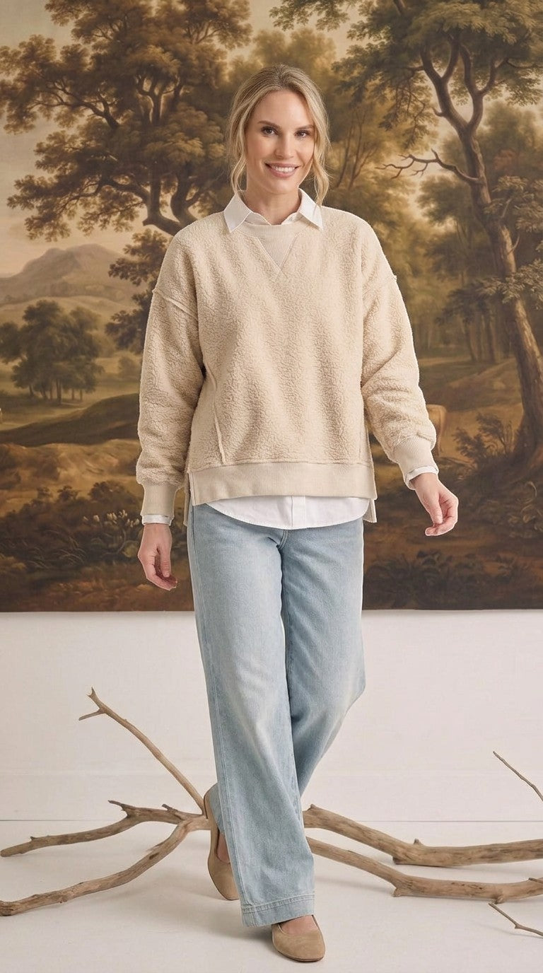 graced The Ashley oversized cream fleece top worn by a blonde model with a white collared shirt and light blue jeans