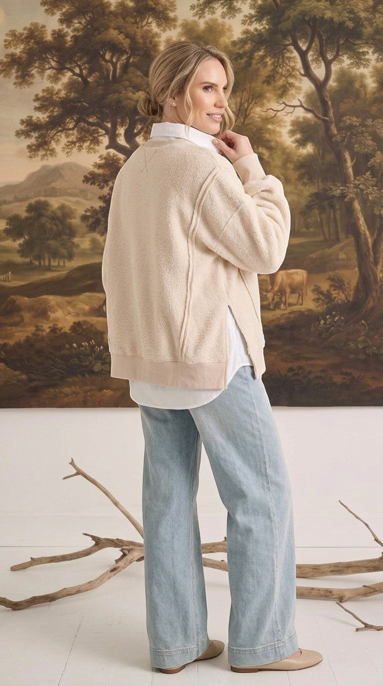 graced The Ashley oversized cream fleece top with side slits worn over a white shirt and light wash jeans
