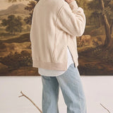 graced The Ashley oversized cream fleece top with side slits worn over a white shirt and light wash jeans