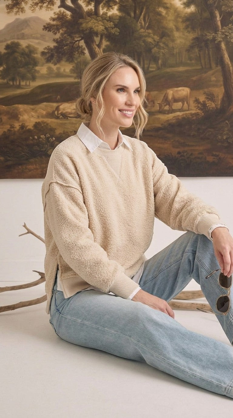 Model wearing graced The Ashley oversized cream fleece top with a white collared shirt underneath and blue jeans