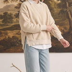 Model wearing graced The Ashley oversized cream brushed fleece top with side slits over a white collared shirt.