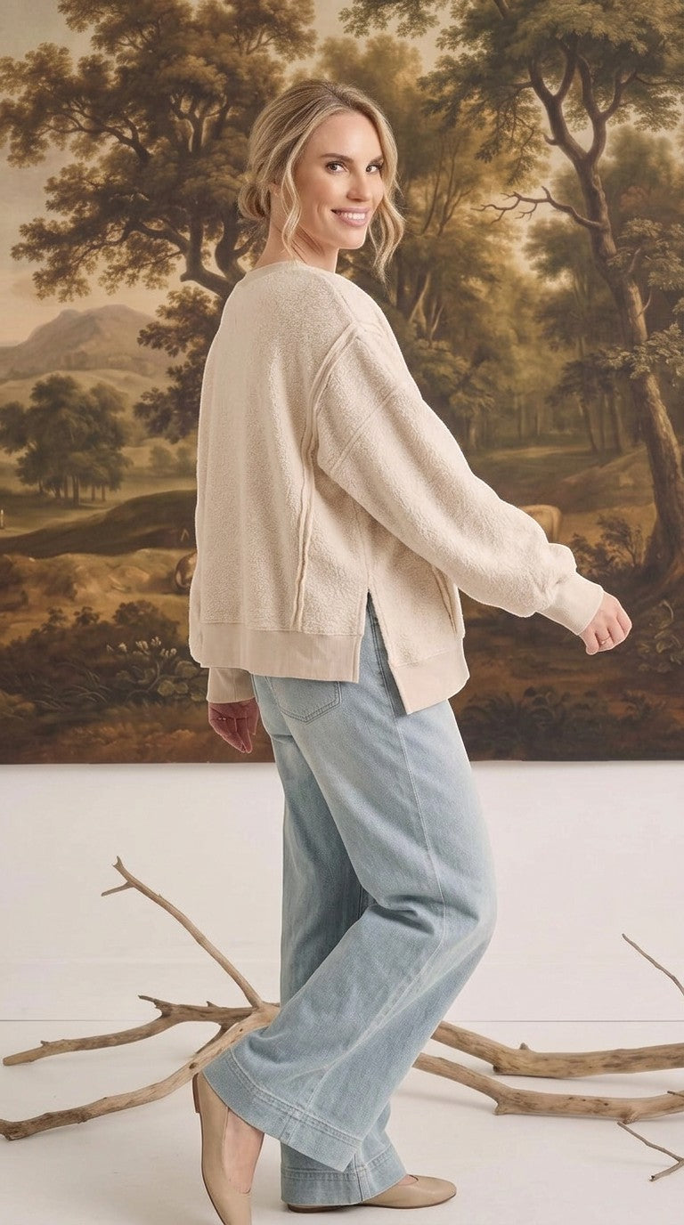 graced The Ashley oversized cream fleece top with side slits worn by a model with light blue jeans