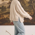 graced The Ashley oversized cream fleece top with side slits worn by a model with light blue jeans