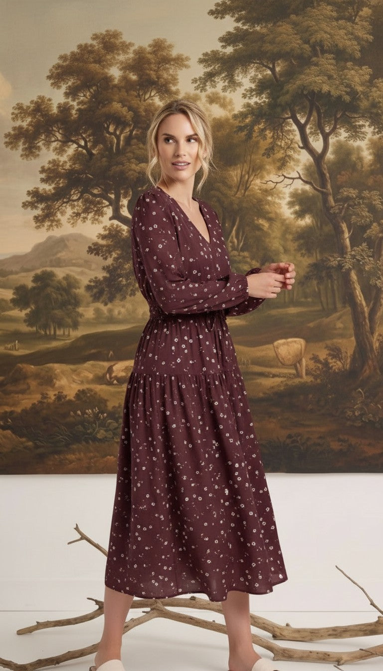 graced Audrey floral midi dress in burgundy with long sleeves, v-neckline, and tiered skirt on a model