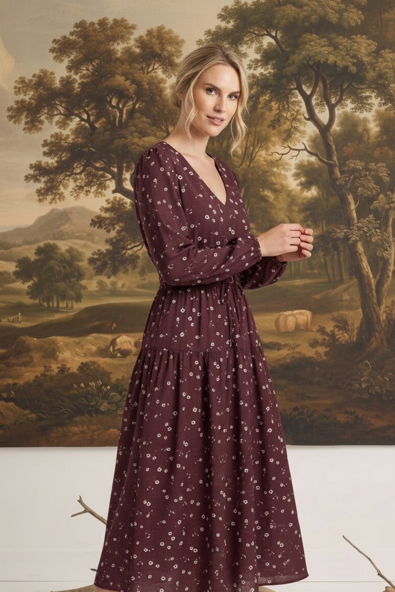 graced Audrey floral midi dress in burgundy with long sleeves, v-neckline, and flowy skirt worn by a blonde model