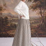 graced Beatrice midi skirt in plaid cotton with a smocked waist, worn with a cream cardigan and tan heeled boots