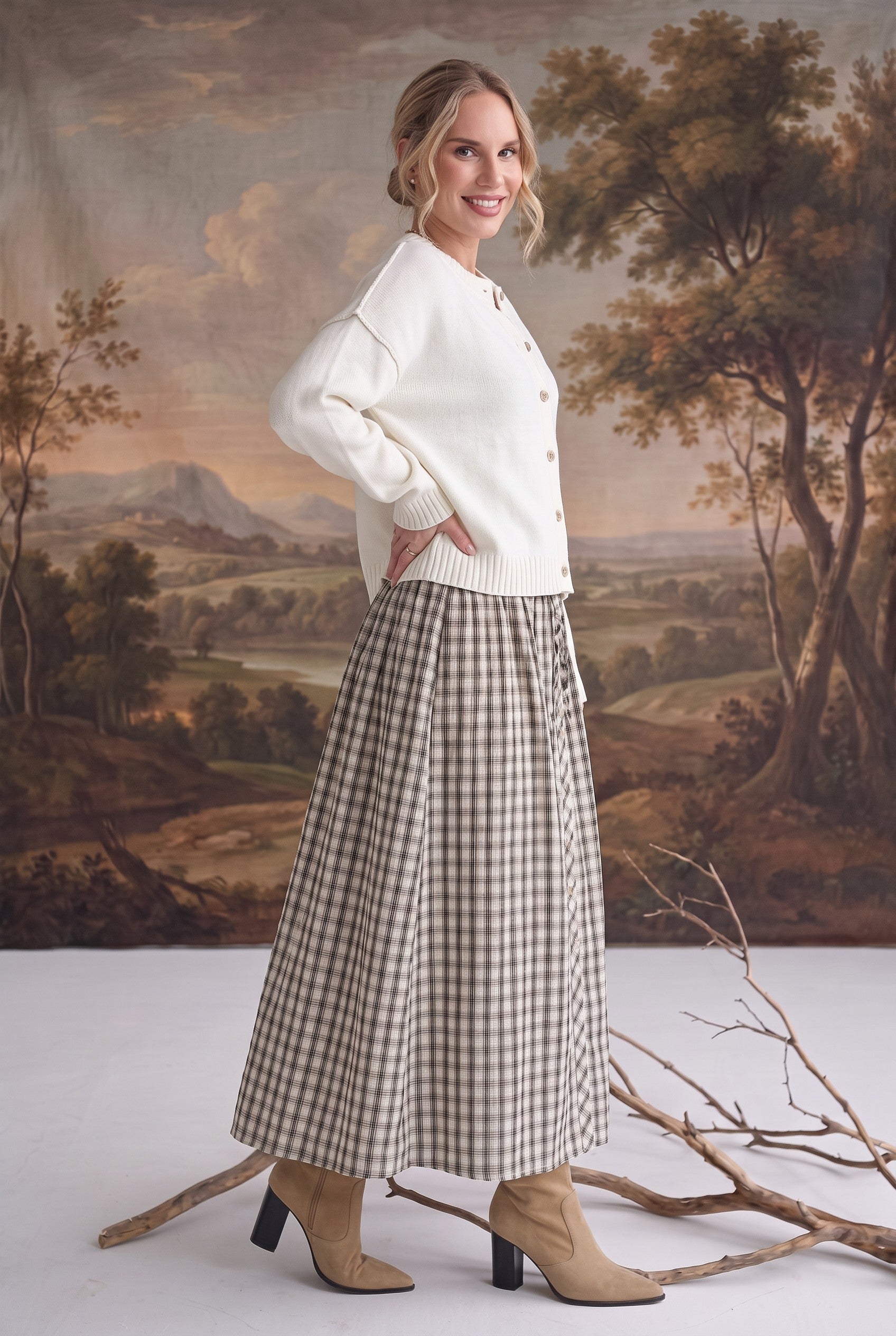 graced Beatrice midi skirt in plaid cotton with a smocked waist, worn with a cream cardigan and tan heeled boots
