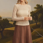 Beige floral lace knit top by Forte featuring intricate lace details and a soft, cozy knit fabric.