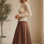 Beige floral lace knit top by Forte featuring intricate lace details and a soft, cozy knit fabric.