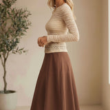 Beige floral lace knit top by Forte featuring intricate lace details and a soft, cozy knit fabric.