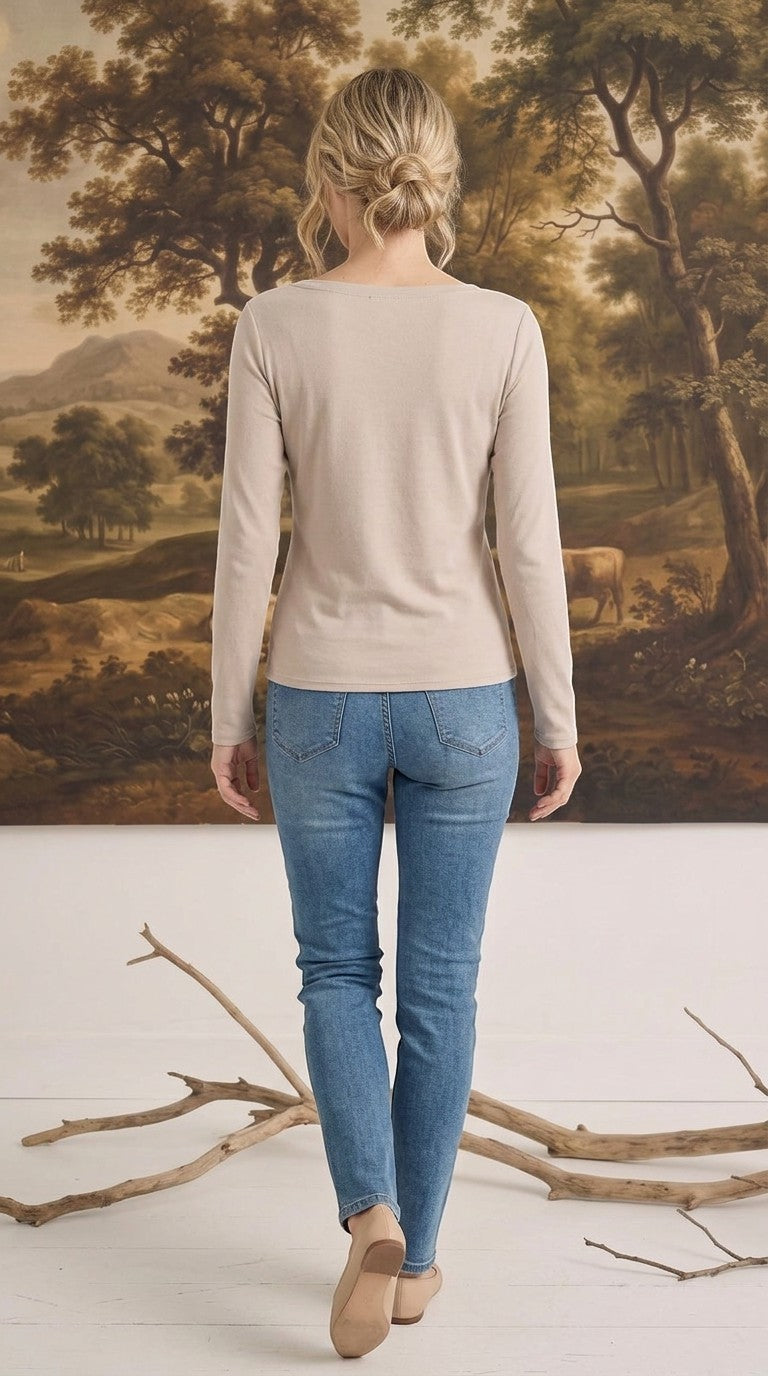 graced beige long sleeve boat neck knit top worn with blue jeans, back view