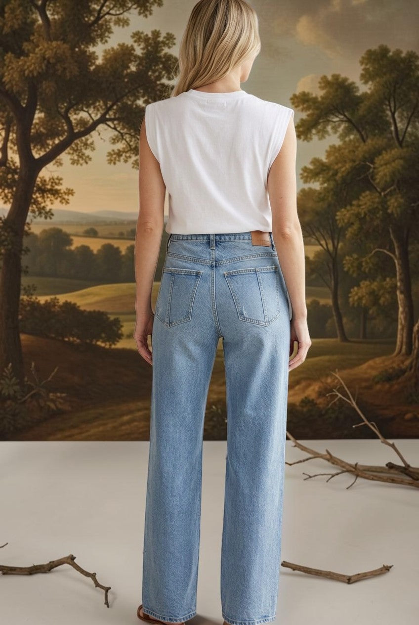 graced Blaine high rise straight leg jeans in light blue denim worn by a woman from the back view