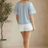 Blue embroidered raglan short sleeve top by Lovestitch, showcasing floral embroidery and casual blouse style.