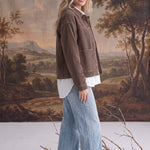 graced The Jess brown corduroy jacket worn by a blonde model with a white shirt and light wash wide-leg jeans