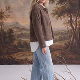 graced The Jess brown corduroy jacket worn by a blonde model with a white shirt and light wash wide-leg jeans