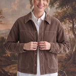 graced The Jess brown corduroy jacket worn by a smiling model over a white shirt and light wash jeans