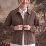 graced The Jess brown corduroy jacket worn by a smiling model over a white shirt and light wash jeans